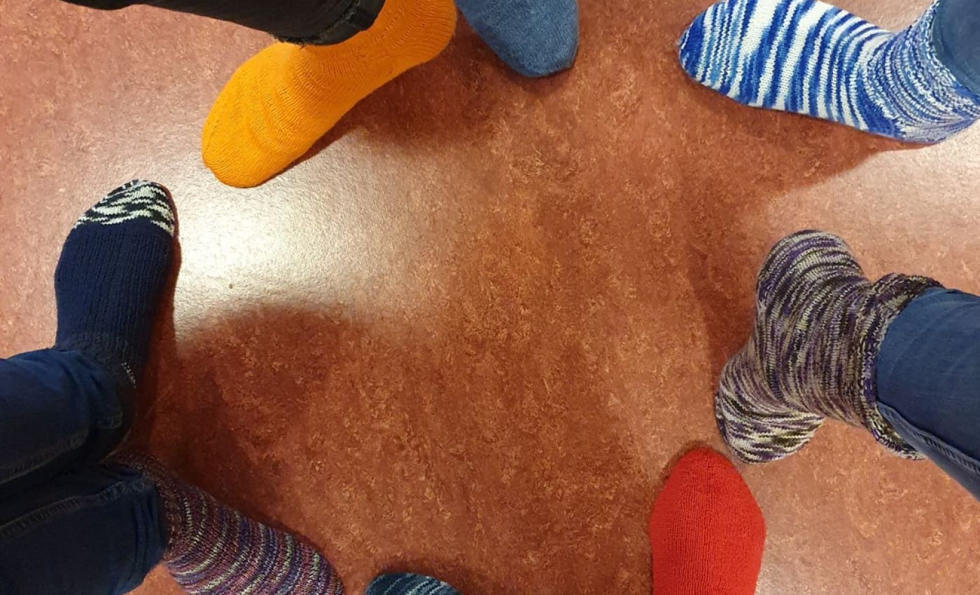 Menschen die im Kreis mit Socken stehen